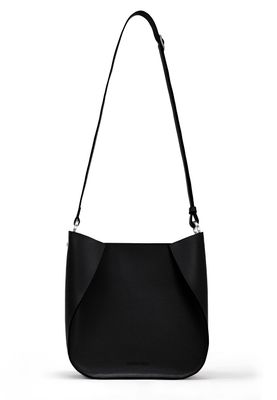 a black handbag with a strap on a white background