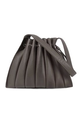 a gray handbag with a long strap