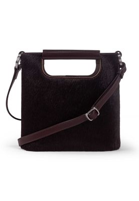 a black handbag with a brown strap