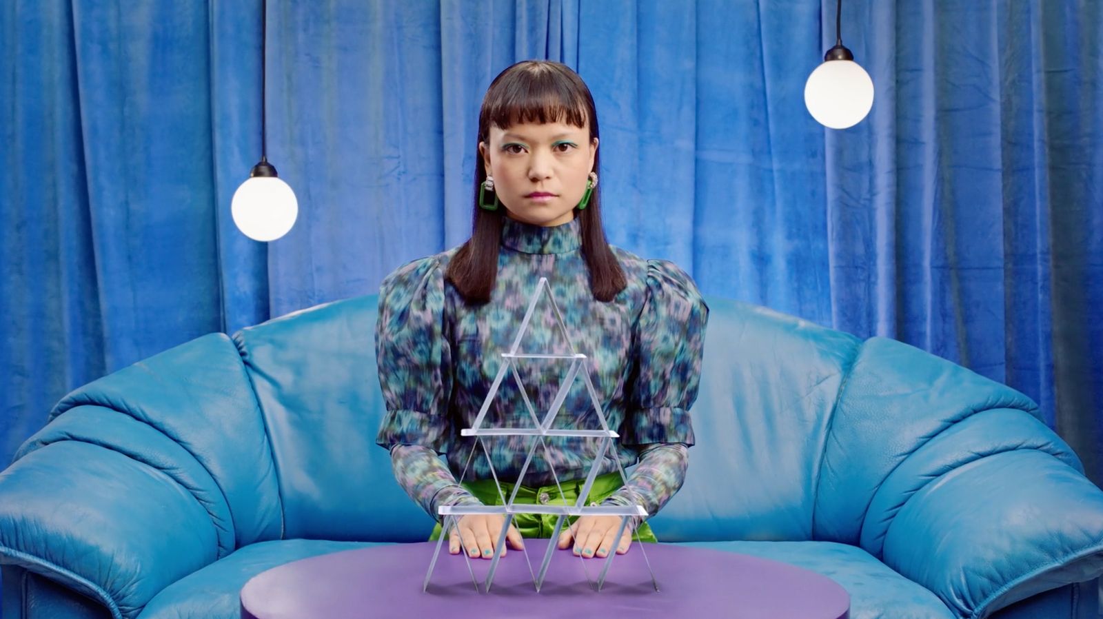 a woman sitting at a table with a cake on it