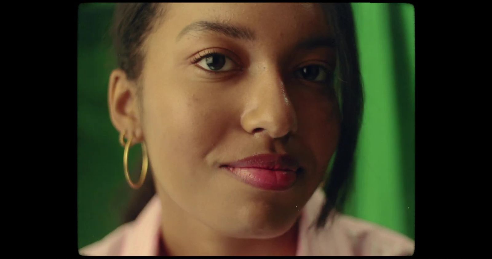 a close up of a person with a green background