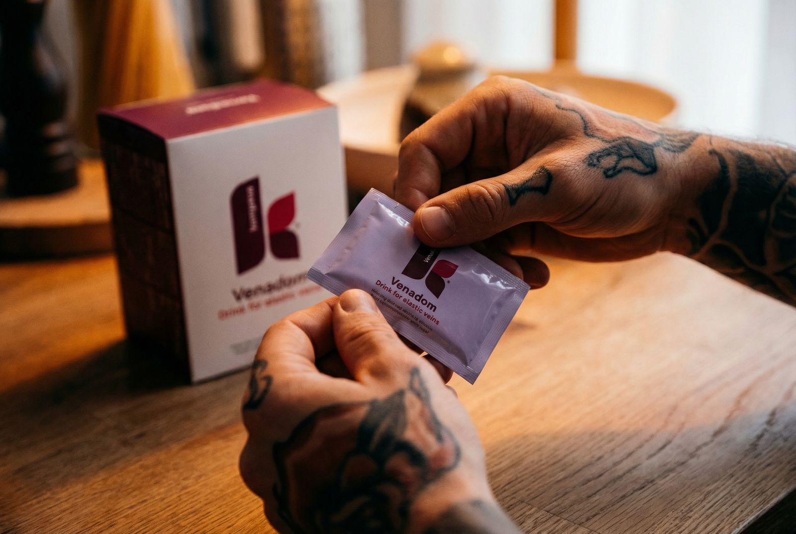 a man with a tattoo on his arm is putting a condom in a packet
