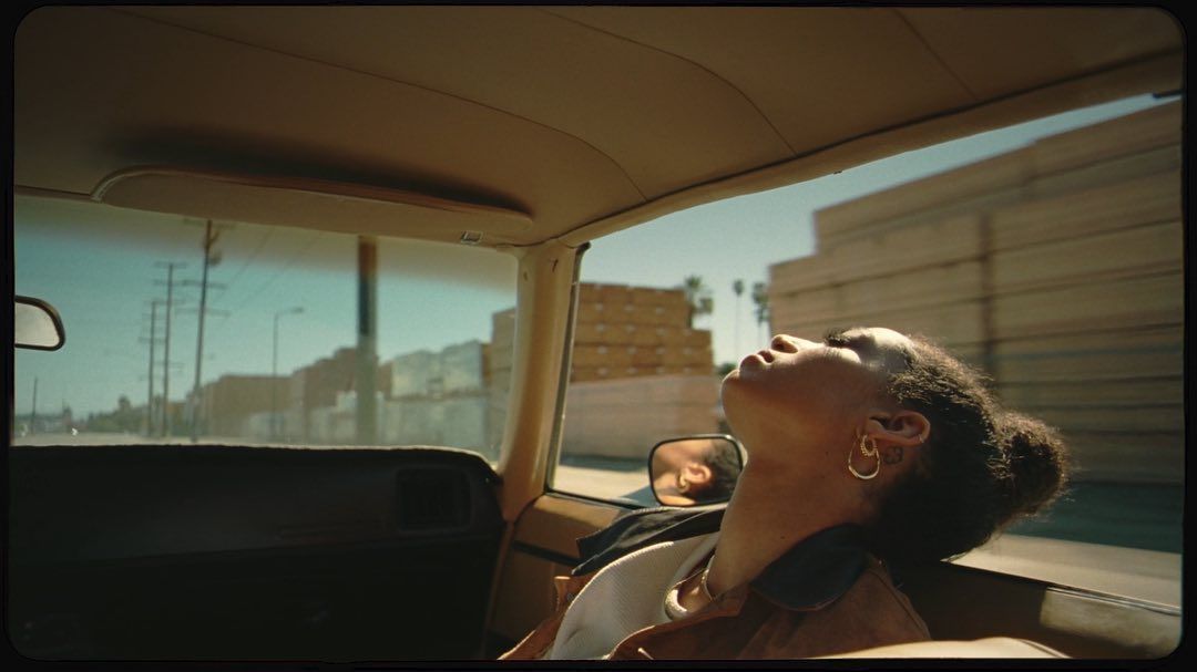 a woman sitting in the back seat of a car