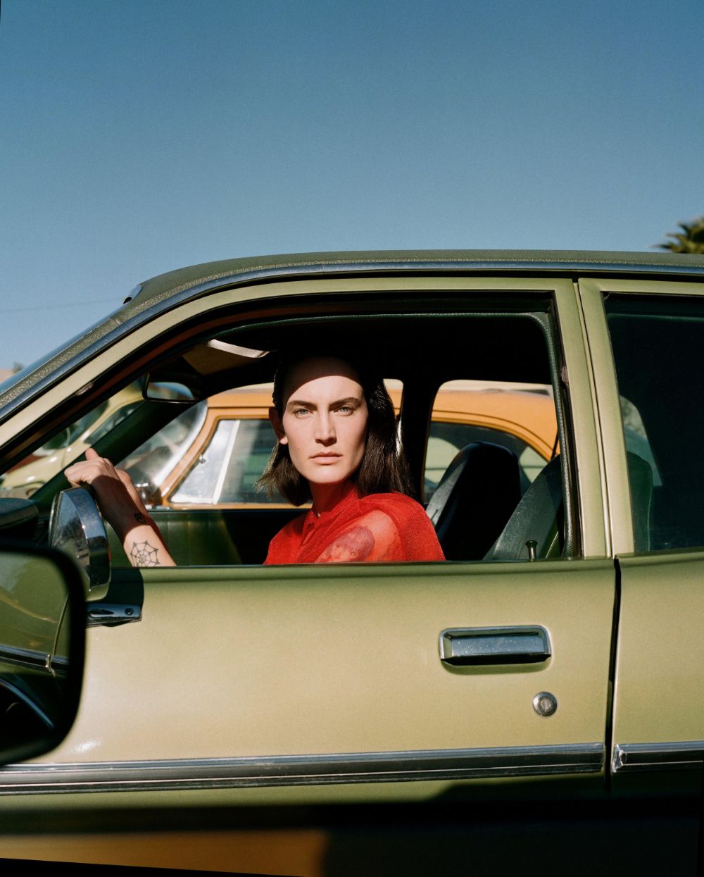 a woman sitting in the driver's seat of a car