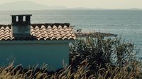 a view of the ocean from a roof of a house