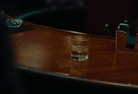 a glass of water sitting on top of a wooden table