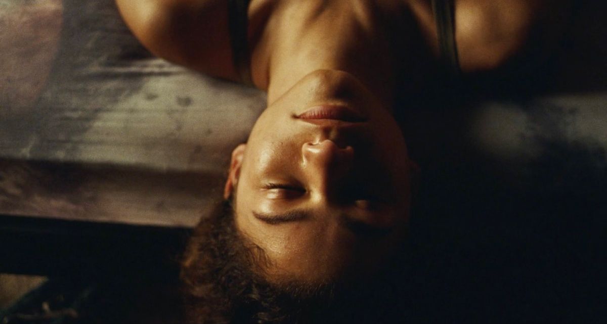 a man with a beard laying on a bed