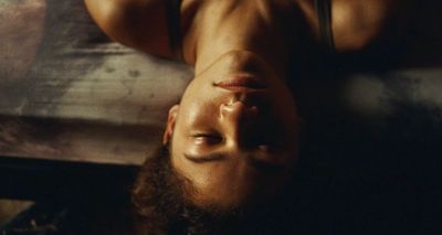 a man with a beard laying on a bed