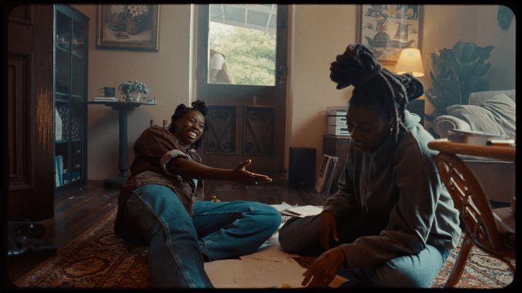 a woman sitting on the floor with a child