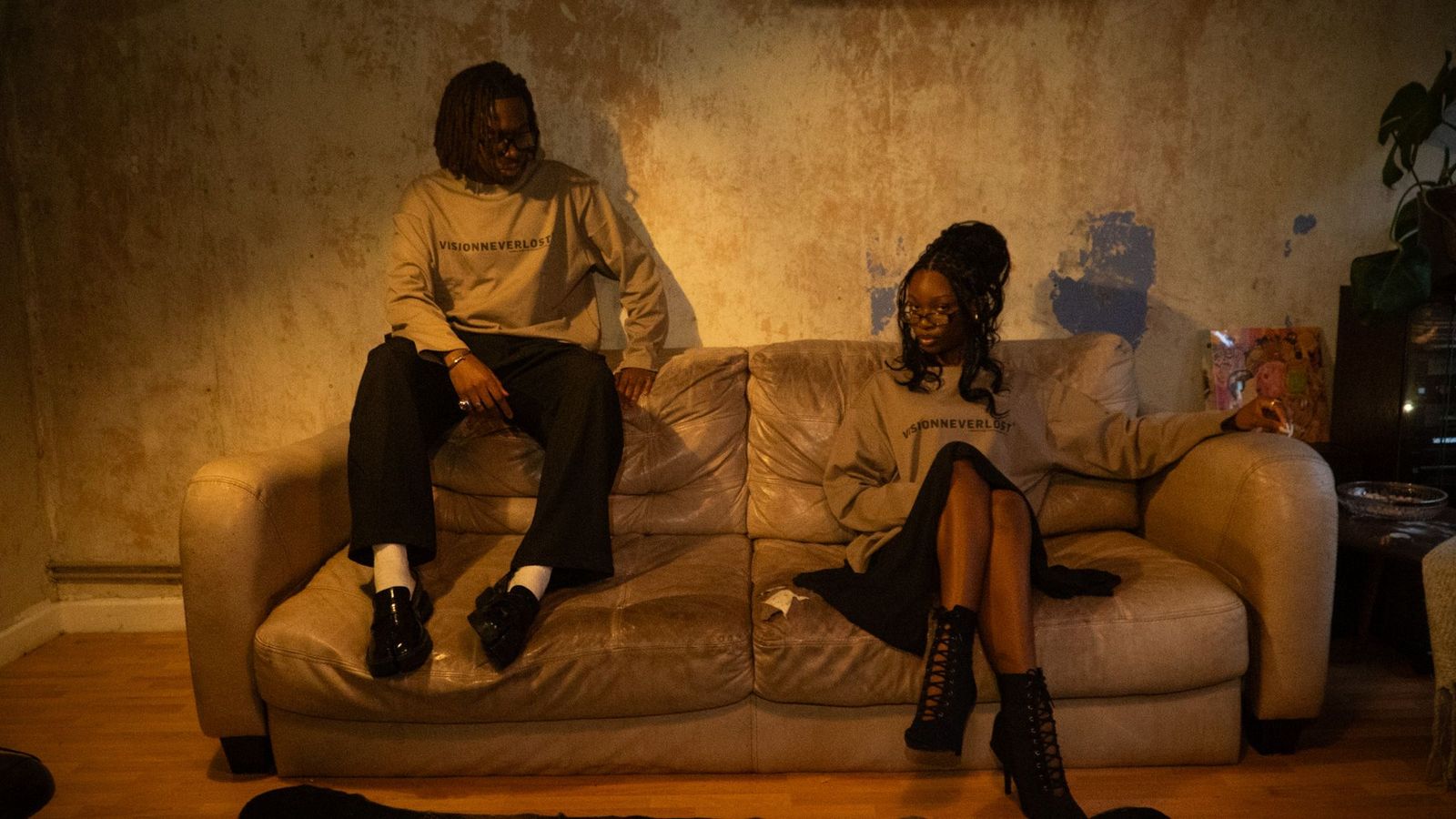 two people sitting on a couch in a living room