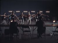 a group of people standing around a table