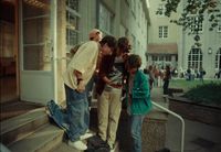 a group of people standing on the steps of a building