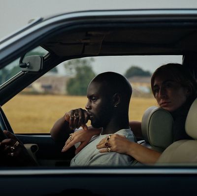 a man and a woman sitting in a car