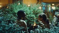 a couple of people that are sitting in some bushes
