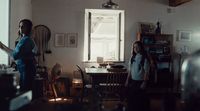 a woman standing in a kitchen next to another woman