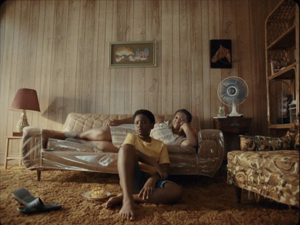 two people sitting on a couch in a living room