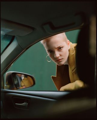 a woman looking out the window of a car