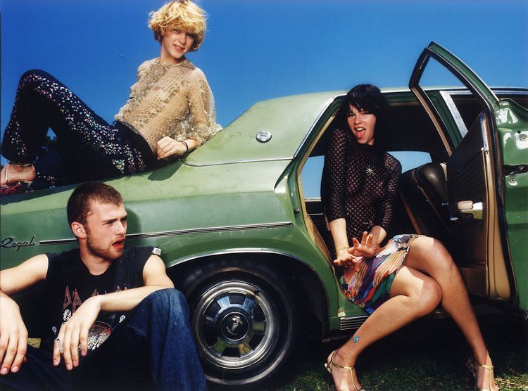 a group of people sitting in the back of a car