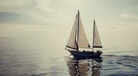 a sailboat floating in the middle of the ocean