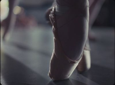 a close up of a ballerina's feet with a blurry background