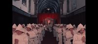 a group of people dressed in white walking down a hallway