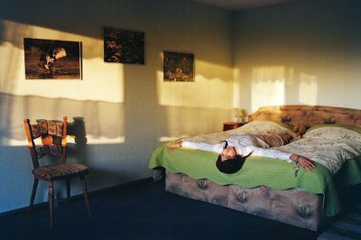 a person laying on a bed in a room
