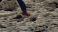 a blurry photo of a person walking on rocks