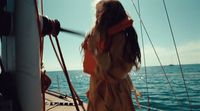 a woman standing on the deck of a boat