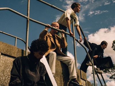 a group of young men sitting on top of stairs