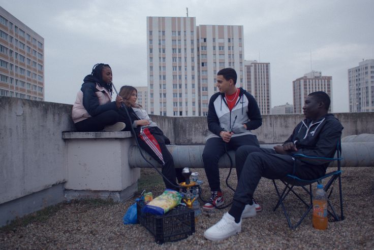 a group of people sitting on top of a roof
