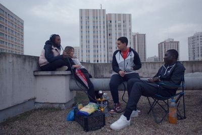 a group of people sitting on top of a roof