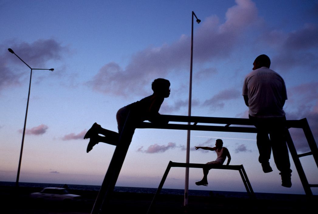 a couple of people sitting on top of a metal structure