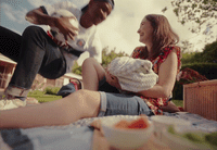 a couple of people that are sitting on a blanket