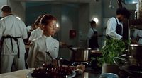 a group of people in a kitchen preparing food