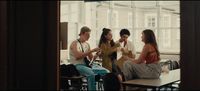 a group of young people sitting around a table