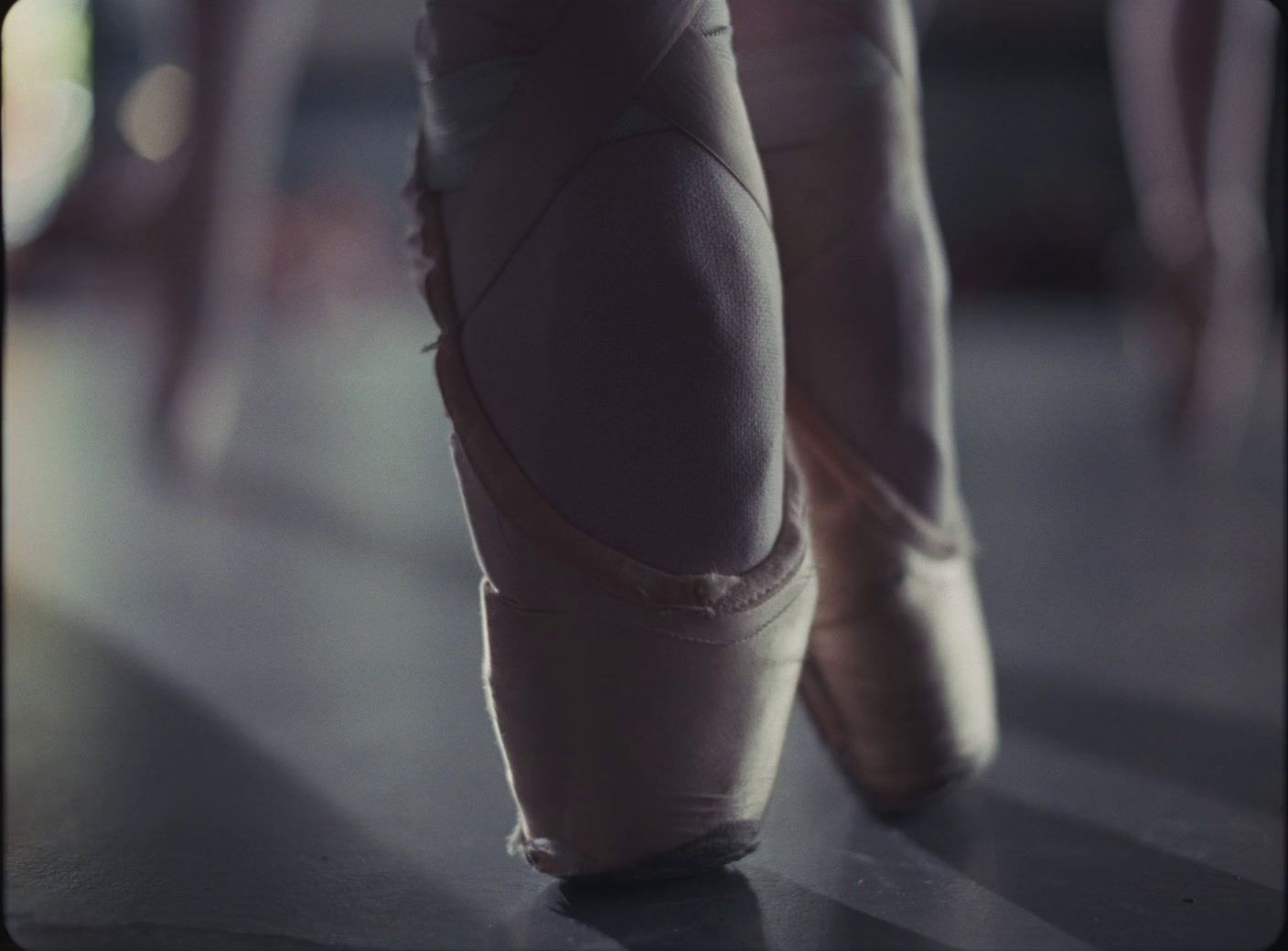 a close up of a person's feet wearing ballet shoes