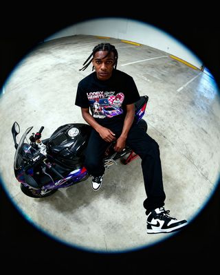 a man sitting on top of a motorcycle