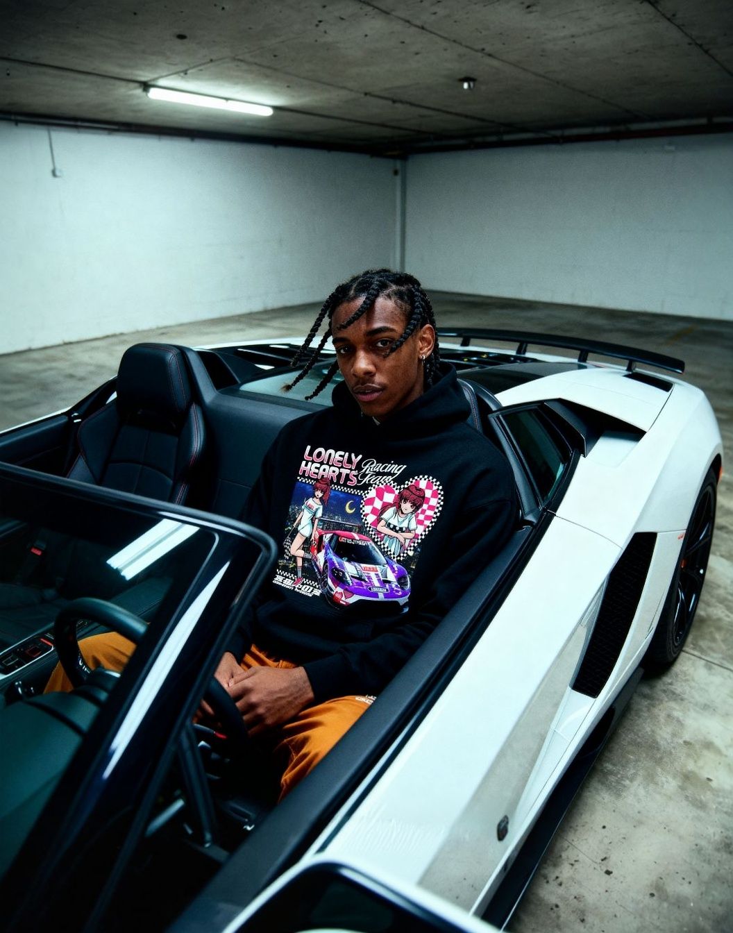 a man sitting inside of a white sports car