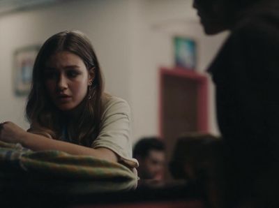 a woman sitting at a table in front of a man