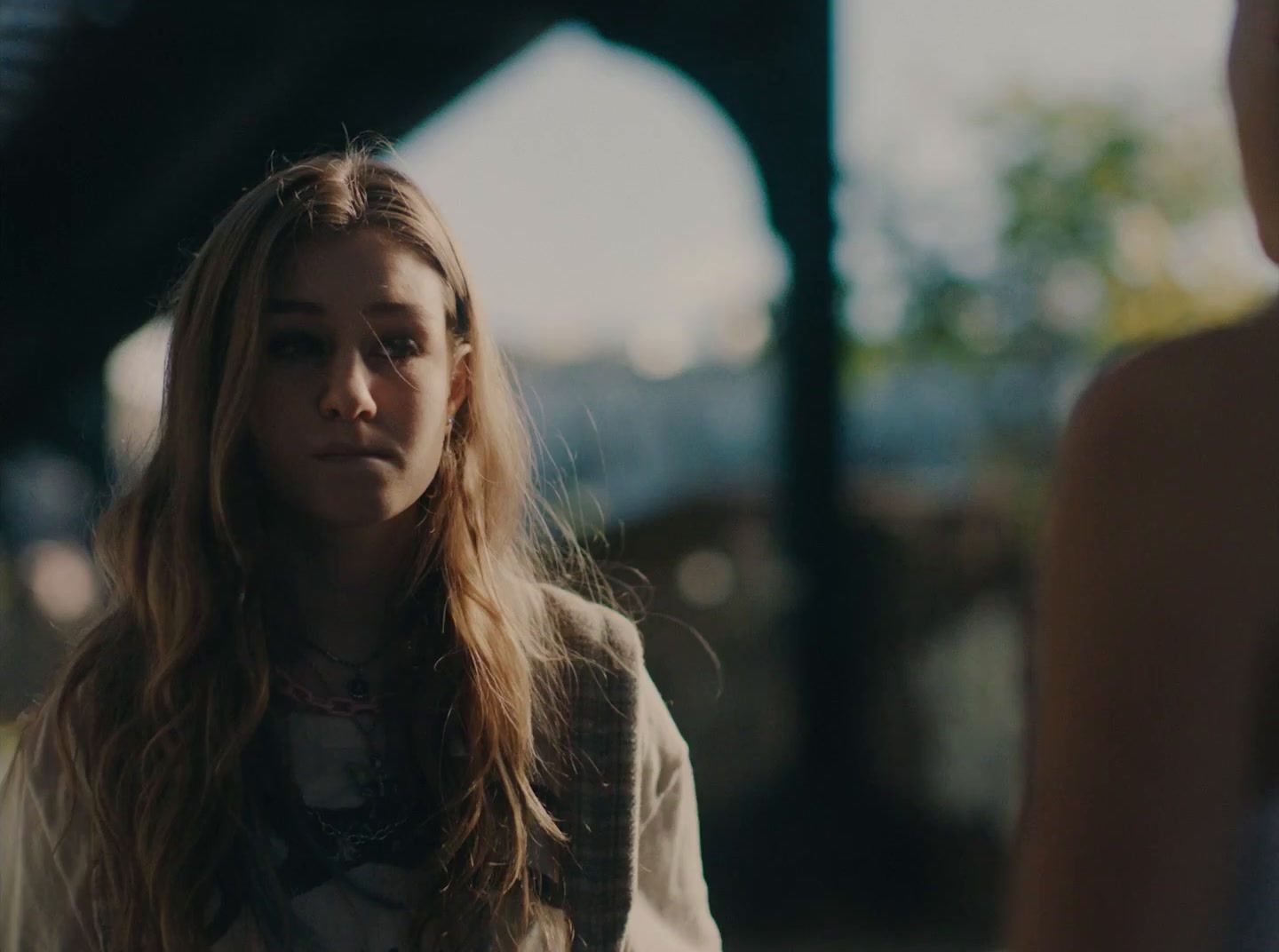 a woman with long hair standing next to another woman