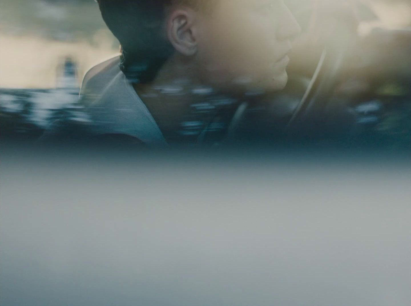 a man sitting in a car with his head out the window