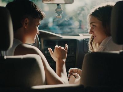 a man and a woman sitting in a car