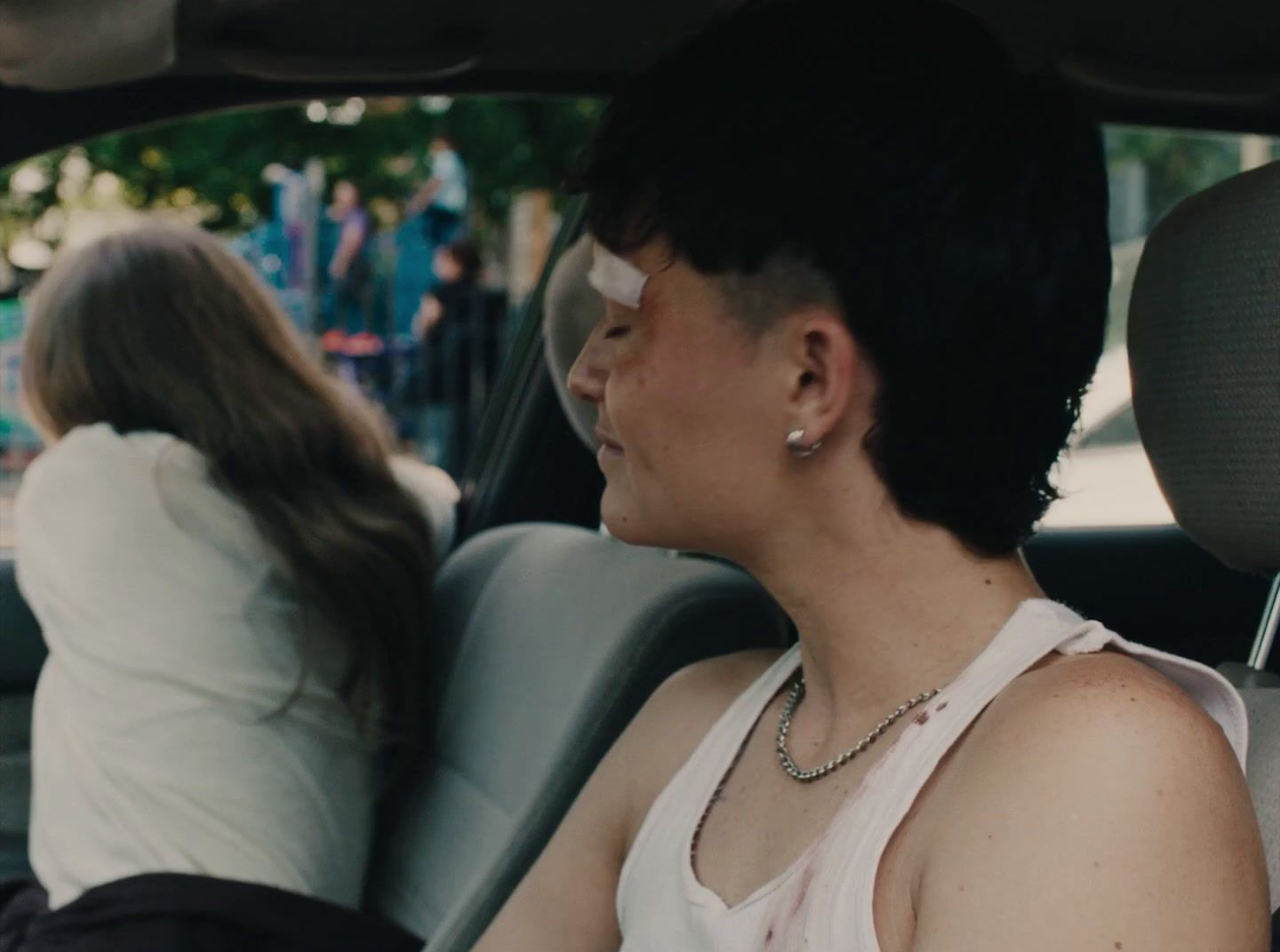 a woman sitting in the back seat of a car