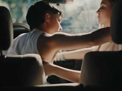 a man and a woman sitting in a car