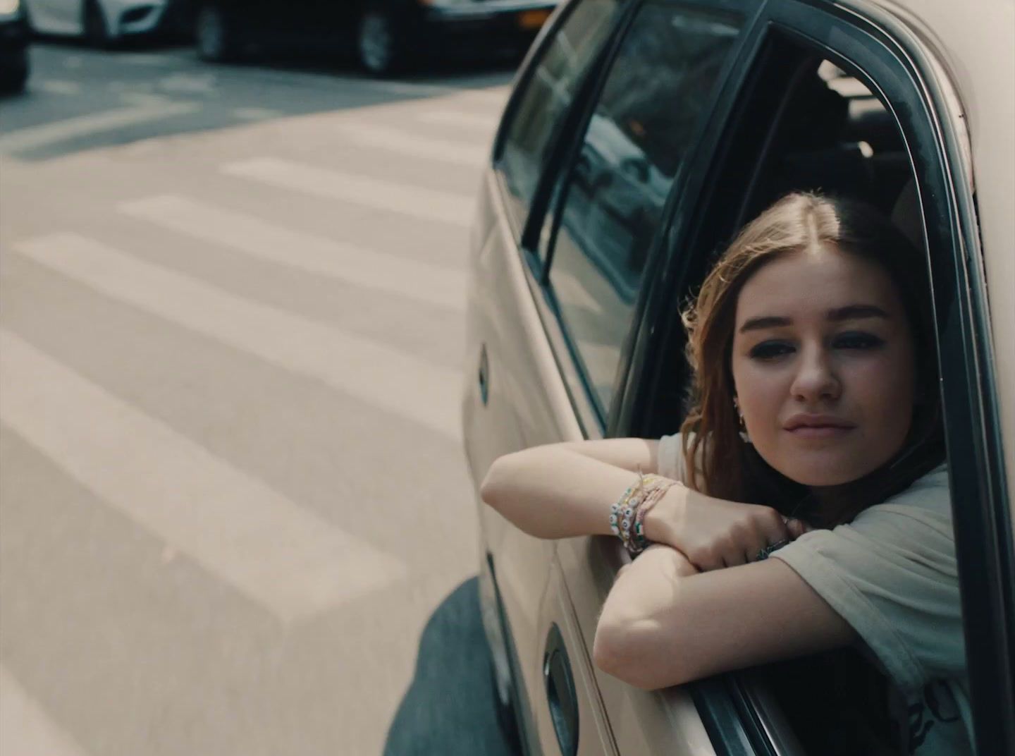 a woman leaning out the window of a car