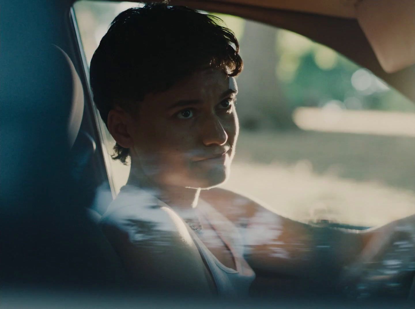 a man sitting in a car looking out the window