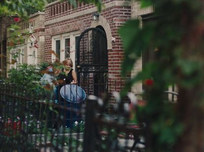 a woman sitting on a bench in front of a building