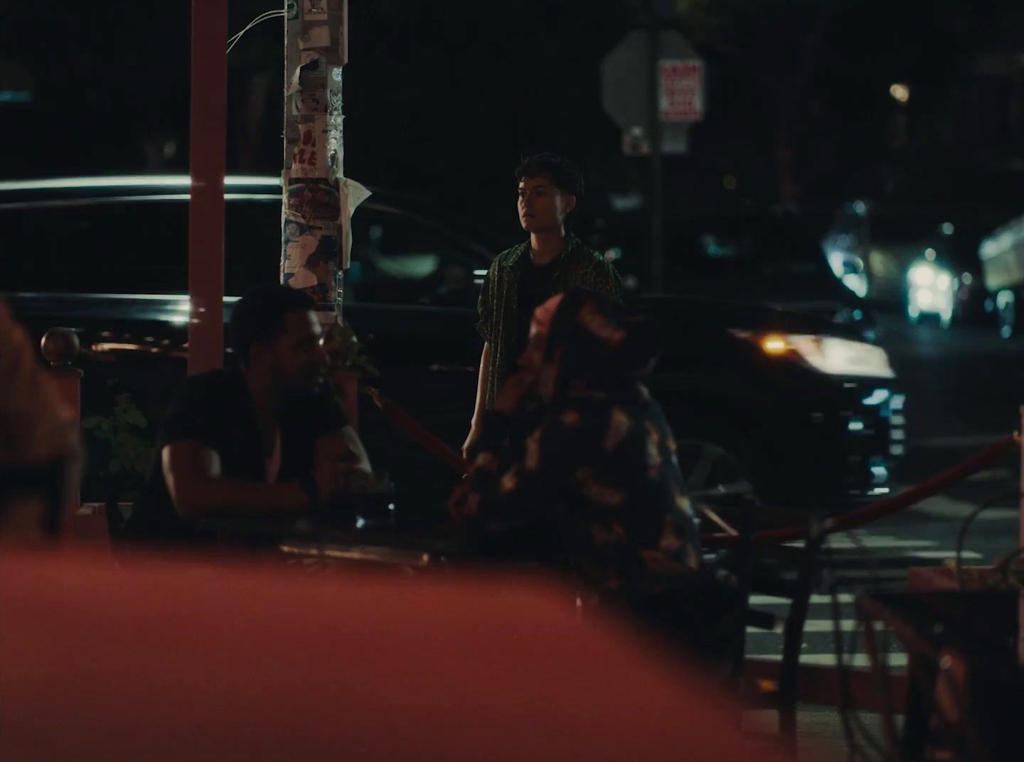 a man and a woman sitting on a bench at night