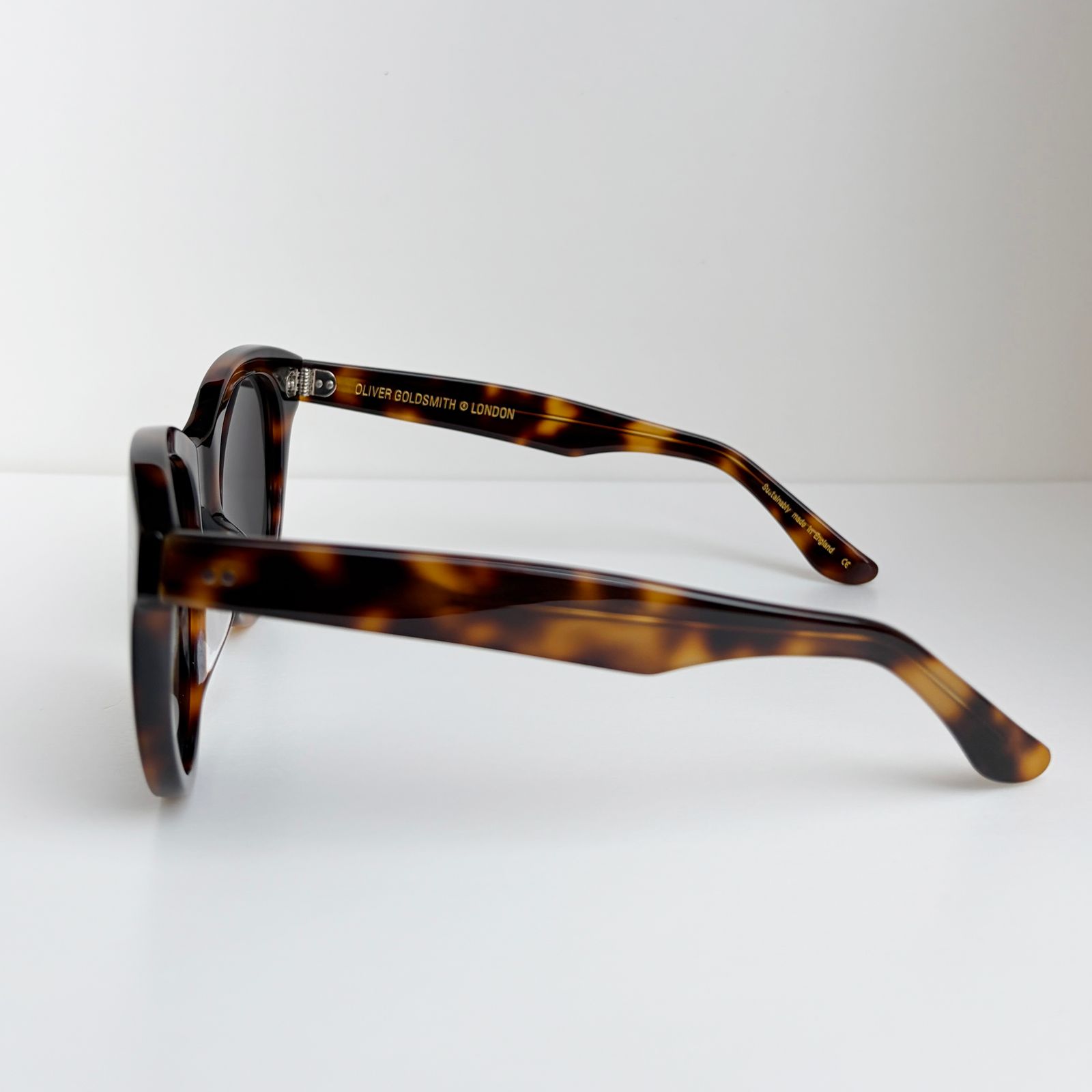 a pair of sunglasses sitting on top of a white table