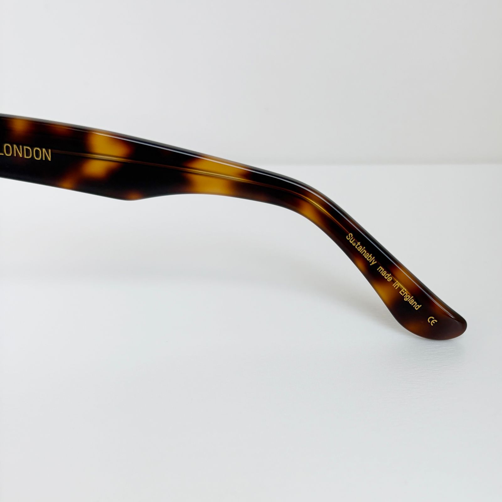 a pair of sunglasses sitting on top of a white table